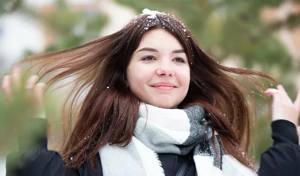 Happy teen girl with long snowy hair in winter