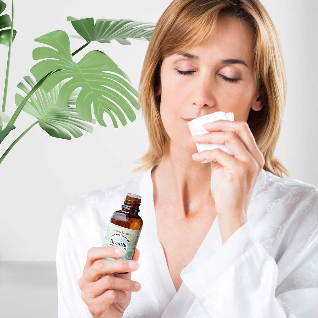 Women smelling Breathe Essential Oil Blend