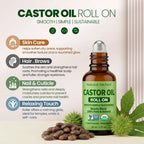 Castor oil roll on bottle with green label and leaves on a beige background