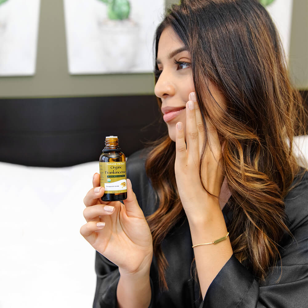 women applying organic frankincense essential oil