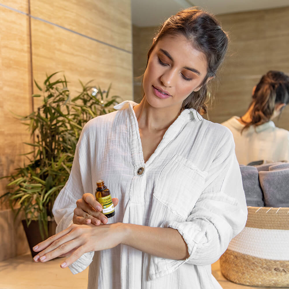 women applying organic frankincense essential oil on skin
