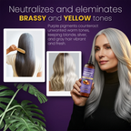 Woman with gray hair holding a bottle of purple hair product against a purple background.