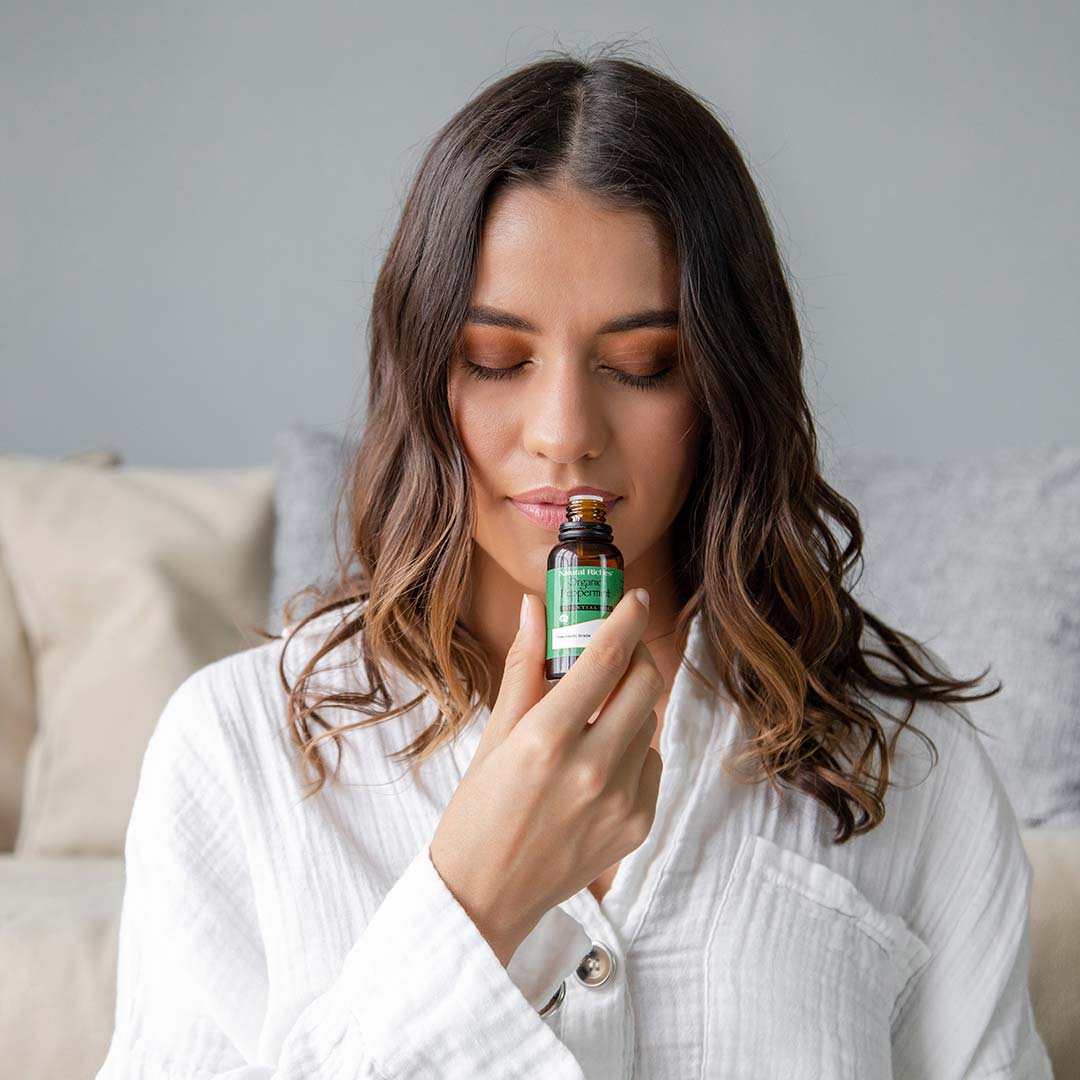 women smelling Organic Peppermint Essential Oil