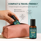 Hand placing Natural Riches eucalyptus castor oil roll-on into a pink zip pouch, with another bottle standing beside it.